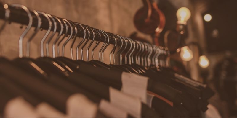 Organized wardrobe with clothing hangers.