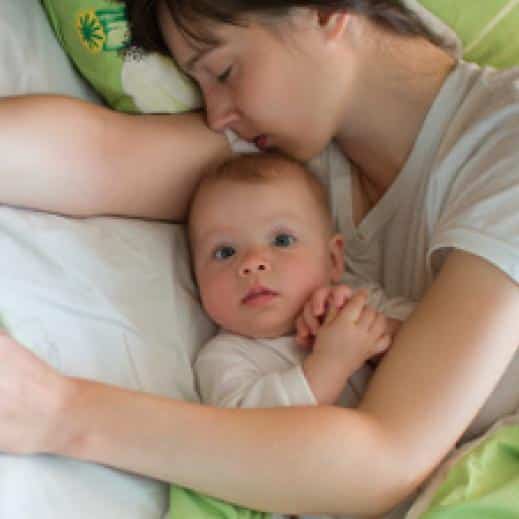 A mother cosleeping with her child