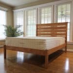 wrapped coil mattress with natural latex - SerenitySpring mattress on bed in bedroom